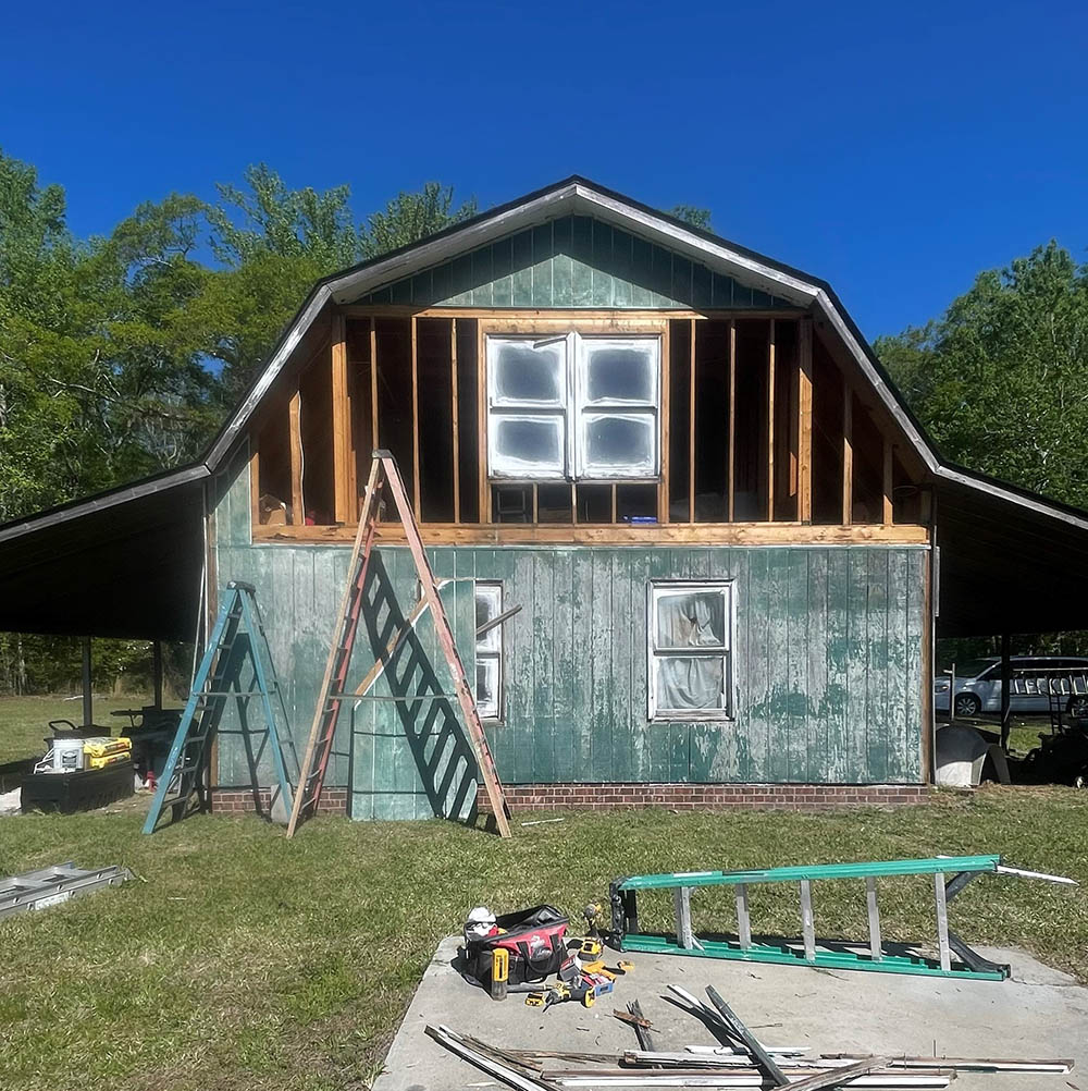 Full exterior panel removal exposing structural wall studs in Fayetteville NC